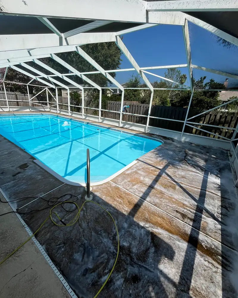 Stained, grimy concrete pool deck before pressure washing